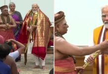 Prime-Minister-Modi-being-handed-over-the-Sceptre-Sengol-by-a-Priest-for-nstalling-it-in-new-Lok-Sabha-Chamber
