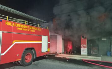 GrowHub Twin Sales Outlet catches fire and fire brigade tenders extinguishing the fire at Sanajy Nagar Chowk, Shashtri Nagar, Jammu on Monday evening. NL Photo: Surjit